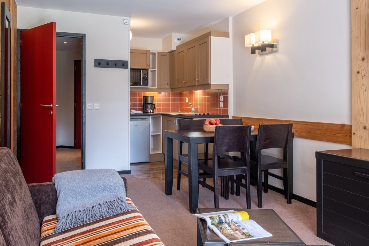 A living room with a couch and a table and chairs