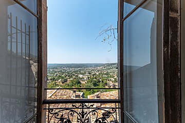 An open window with a view of a small town