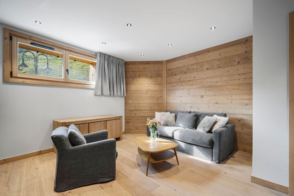 A living room with a couch and a chair