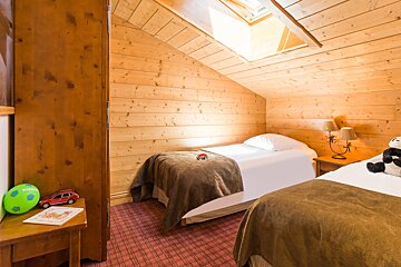 A bedroom with two beds and a toy car on the table