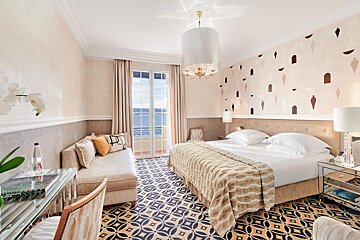 A hotel room with a large bed and a couch