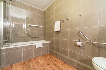 A bathroom with a bathtub and a toilet