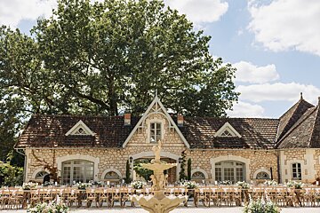 A large stone building with a fountain in front of it