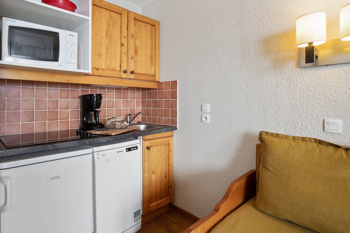 A small kitchen with a microwave and a dishwasher