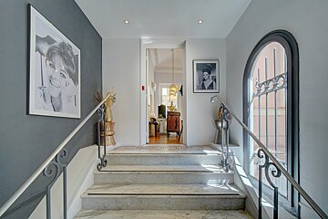 A staircase with a picture of audrey hepburn on the wall