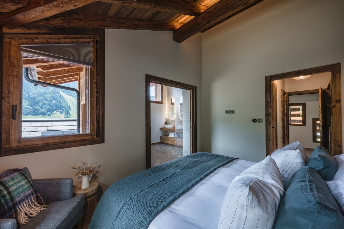 A bedroom with a king size bed and a chair