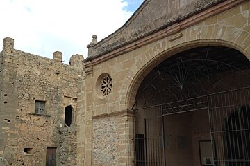 an old monastery building and gate in mallorca