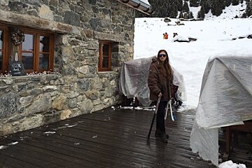 a girl stood on a terrace with snow shoes