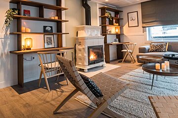 A living room with a fireplace and a chair