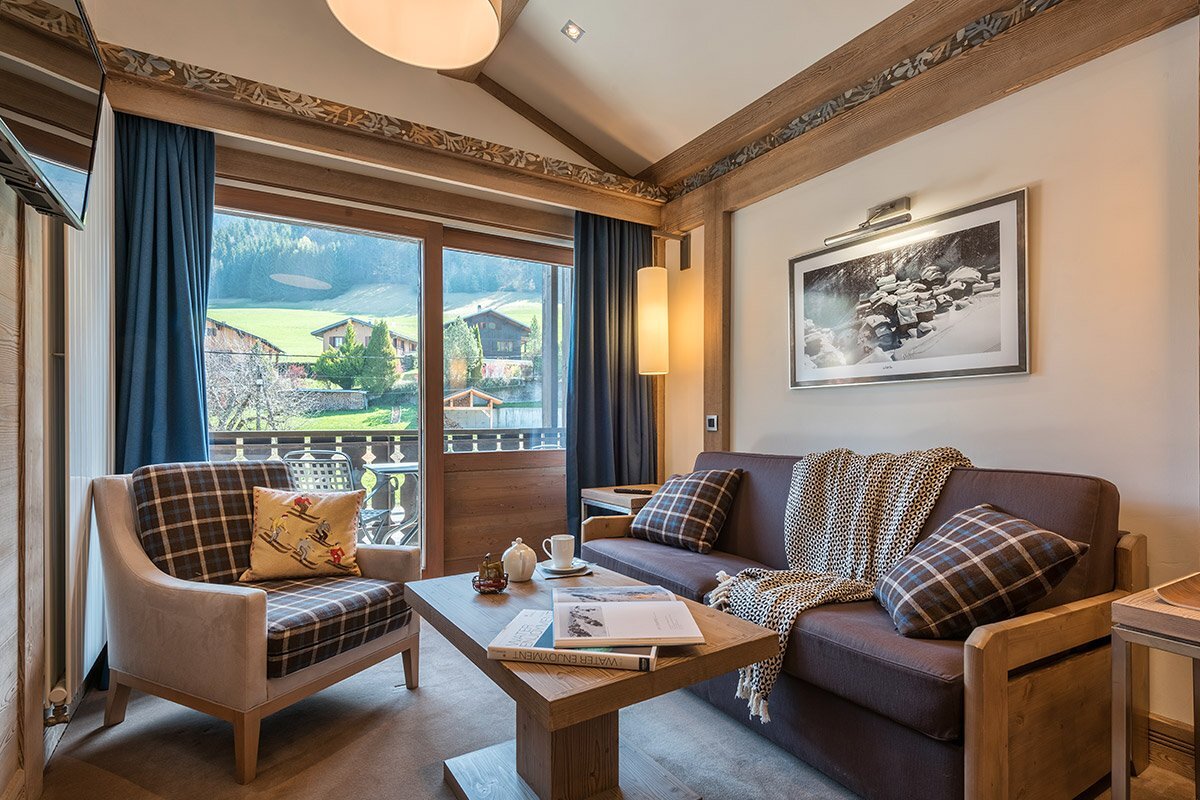 A living room with a couch and two chairs