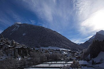 Snow Covered Nyon under Blue Skies