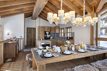A wooden table with plates of food on it