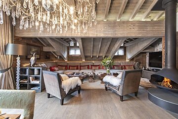 A living room with a couch and chairs and a fireplace