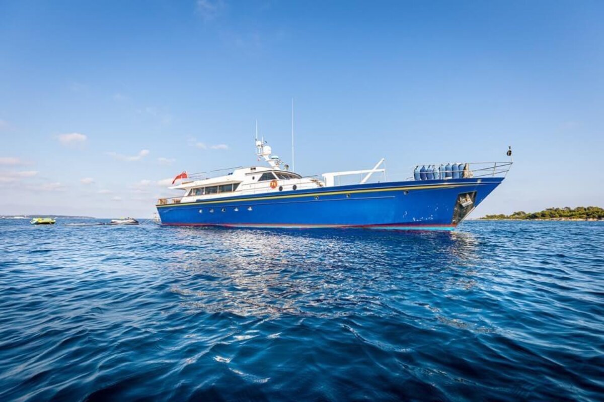 A large blue boat is floating in the ocean