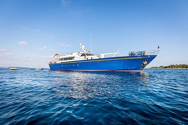 A large blue boat is floating in the ocean