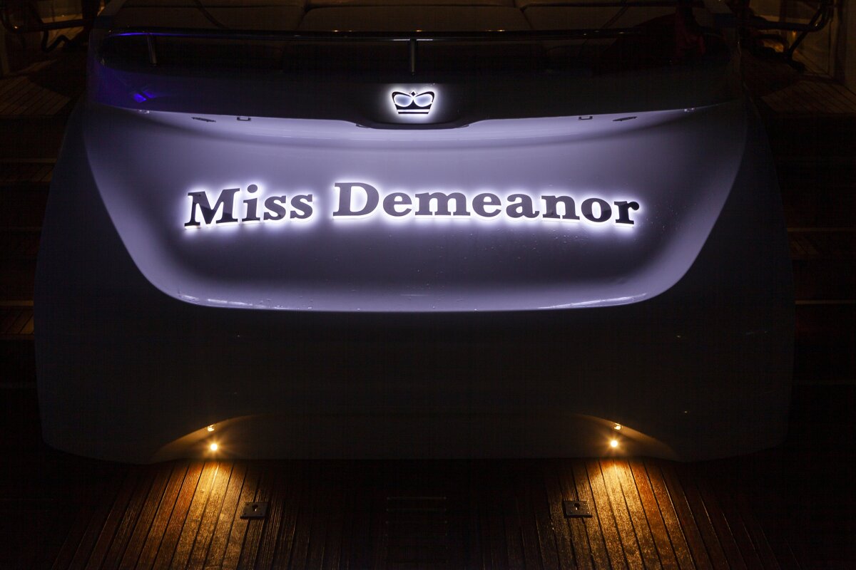 The back of a boat that says miss demeanor