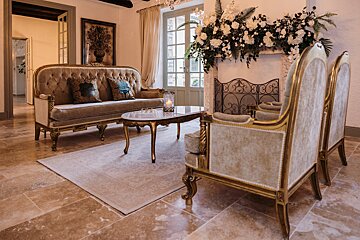 A living room with a couch and two chairs