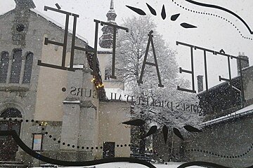 the view out of the window of the church opposite during snow