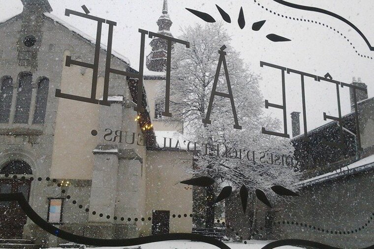 the view out of the window of the church opposite during snow