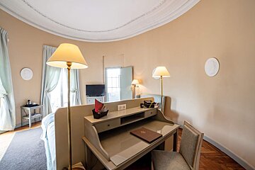 A desk in a hotel room has a menu on it