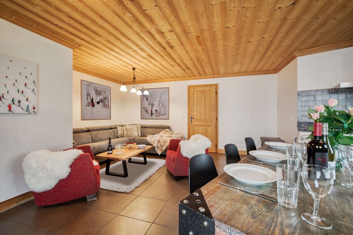 A bottle of red wine sits on a table in a living room