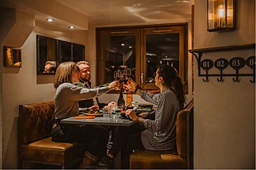 A group of people toasting with wine in a restaurant