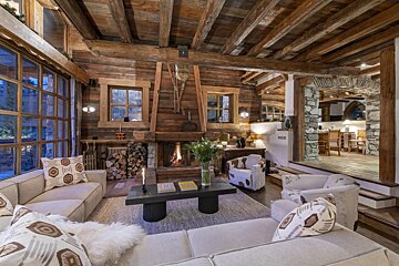 A living room with a fireplace and a couch and chairs