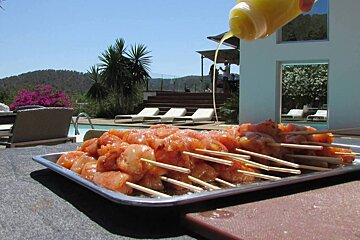 some scewers of seafood being prepared