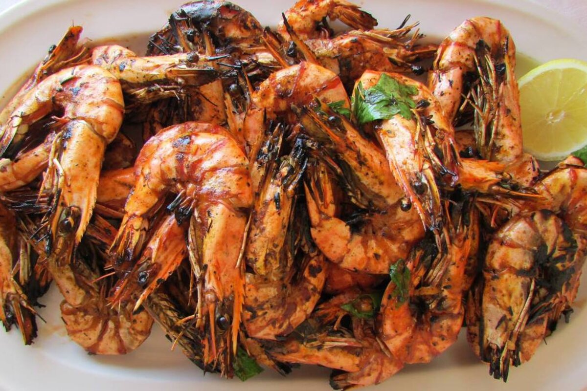 a plate of grilled prawns