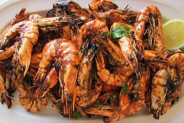 a plate of grilled prawns