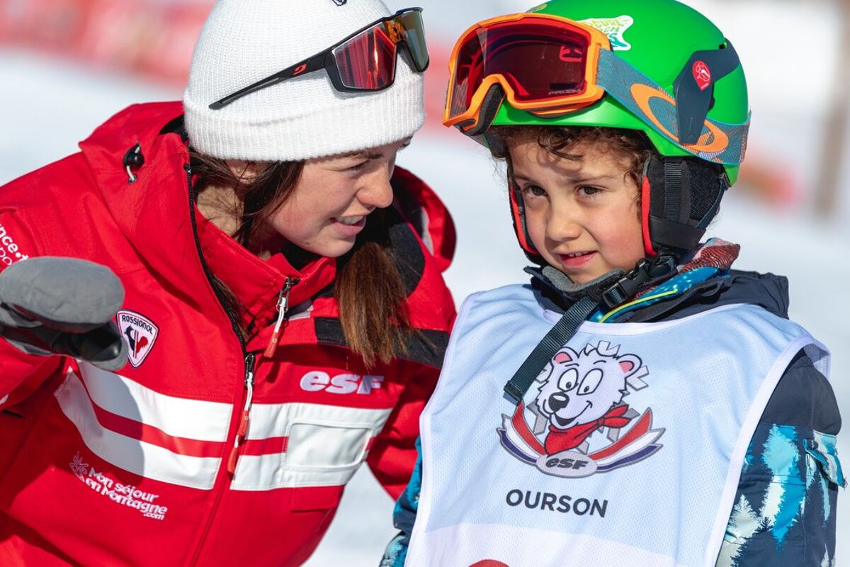 A person wearing a vest that says ourson on it