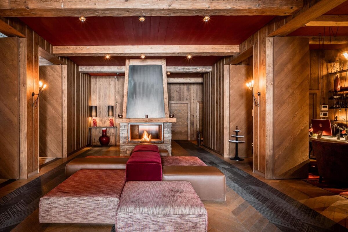 A living room with a fireplace and a red ceiling