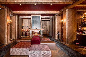 A living room with a fireplace and a red ceiling