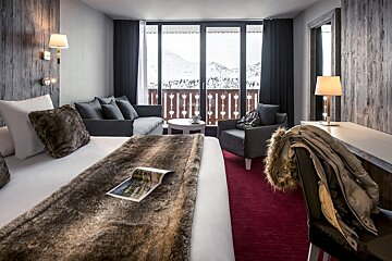 A hotel room with a large bed and a couch