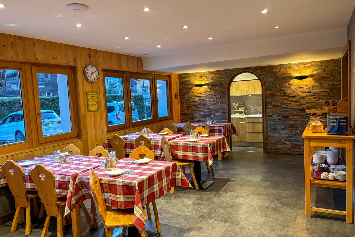 A restaurant with tables and chairs and a clock on the wall