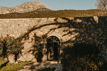 A stone archway with a mountain in the background
