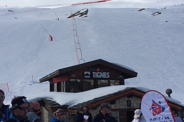 a piste with a small wooden hut in front