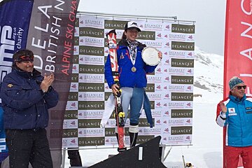 a ski racer holding a silver plate
