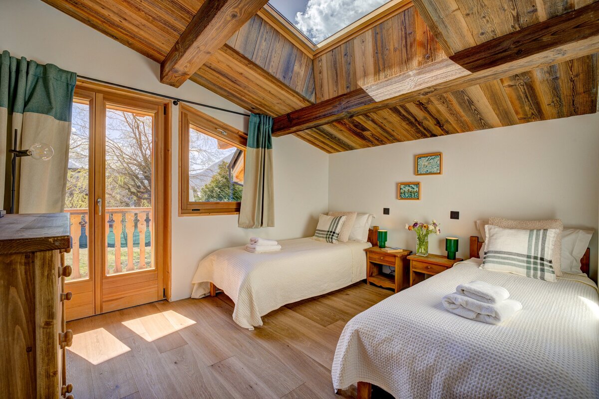 A bedroom with two twin beds and a skylight