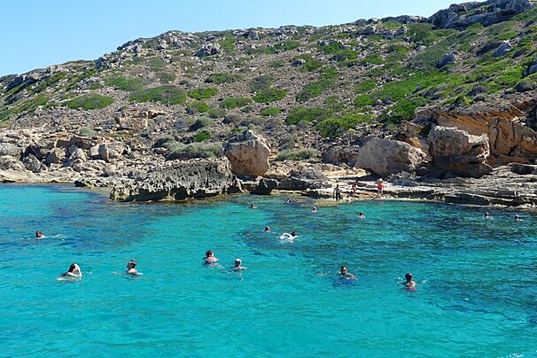 lots of people swimming in the sea in mallorca