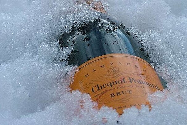 a bottle of champagne in snow