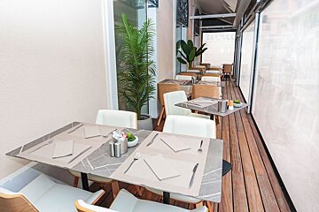 A restaurant with tables and chairs and a sign that says ' a ' on it