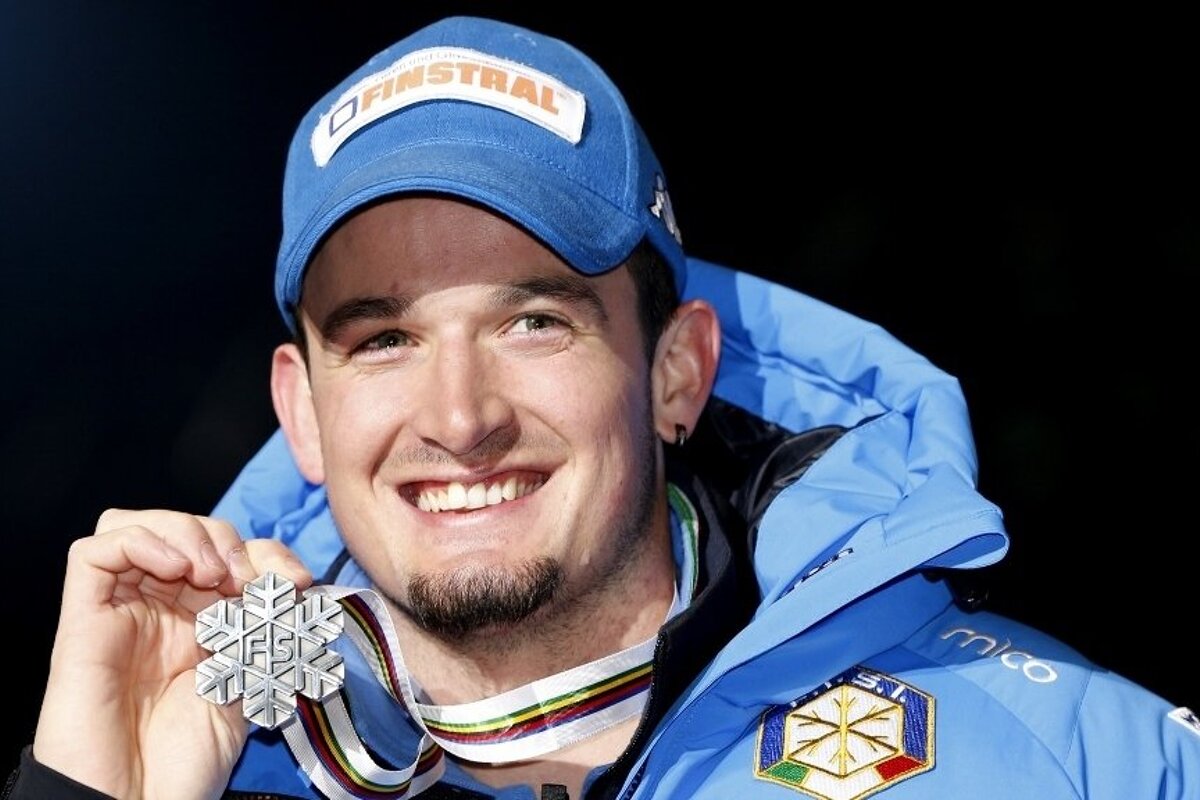 a skier holiding up a medal