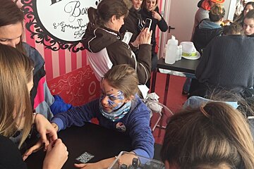kids getting their faces and fingernails painted