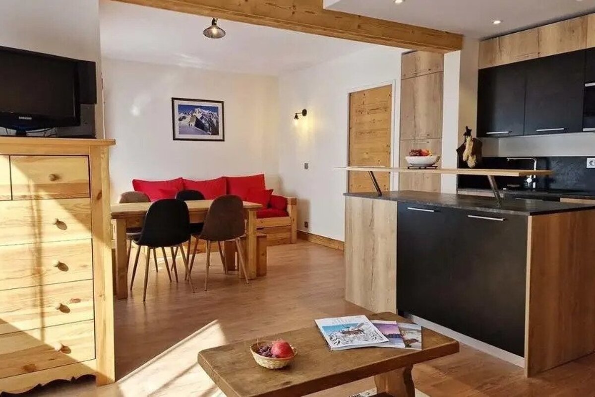 A living room with a couch , table , chairs and a television