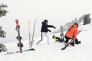 A person wearing an orange jacket with the word ross on it