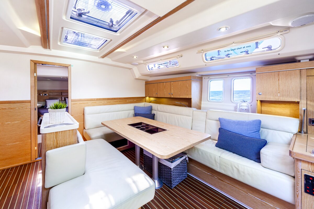 A living room with a table and a sign that says ' the high shelf at sea '