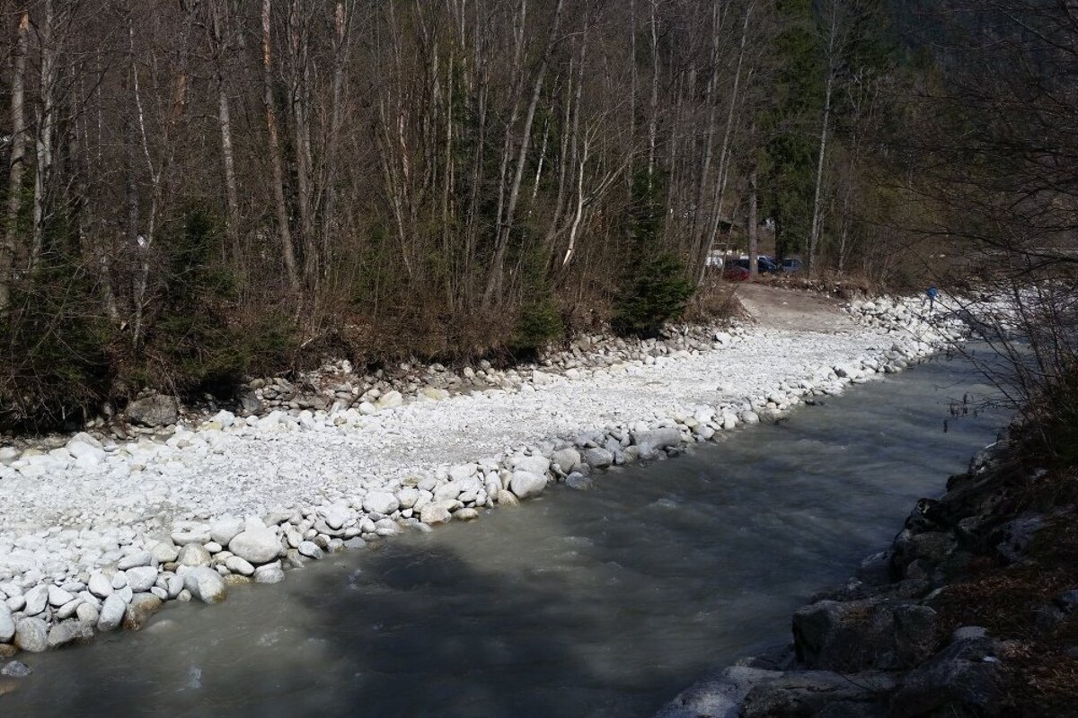a river with debris piled up on one side