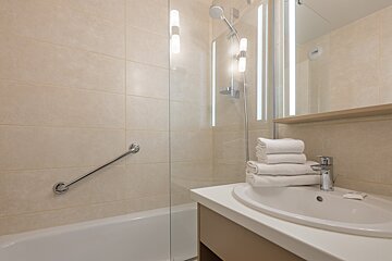 A bathroom with a sink a tub and a shower