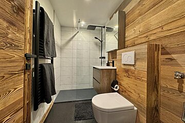 A bathroom with a toilet a sink and a mirror